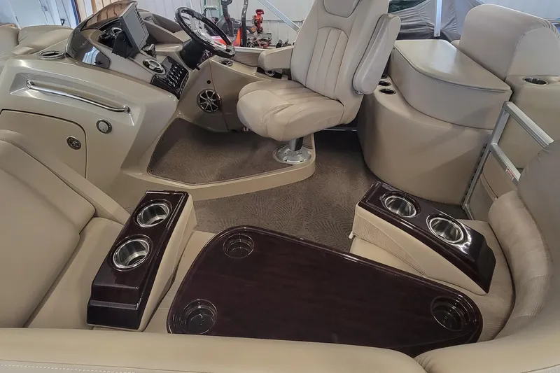 Slide: The Image of Interior of a 2011 Bennington 2575 RCW 3 I/O boat with beige seating and cup holders. - 9