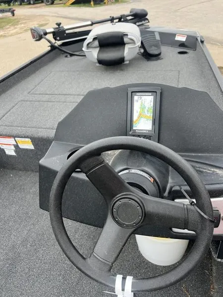 Slide: The Image of 2023 Crestliner 1700 Storm boat interior with steering wheel and fish finder. - 7