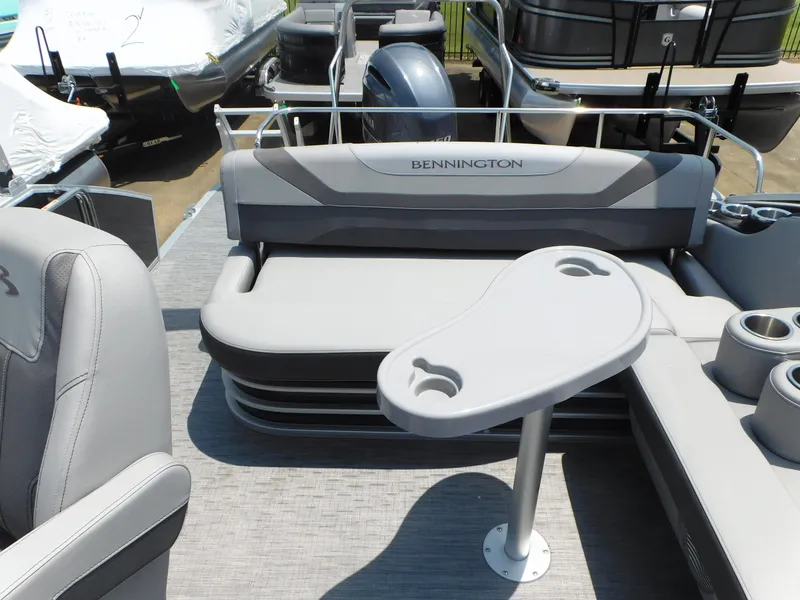Slide: The Image of 2023 Bennington 22 SXSB pontoon boat interior with seating and table. - 7