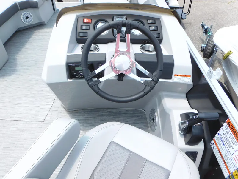 Slide: The Image of 2023 Bennington 22 SXSB boat helm with steering wheel and control panel. - 9