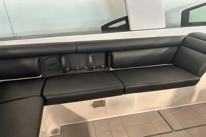 Slide: The Image of 2023 Aviara AV32 boat interior with black leather seating and cup holders. - 11