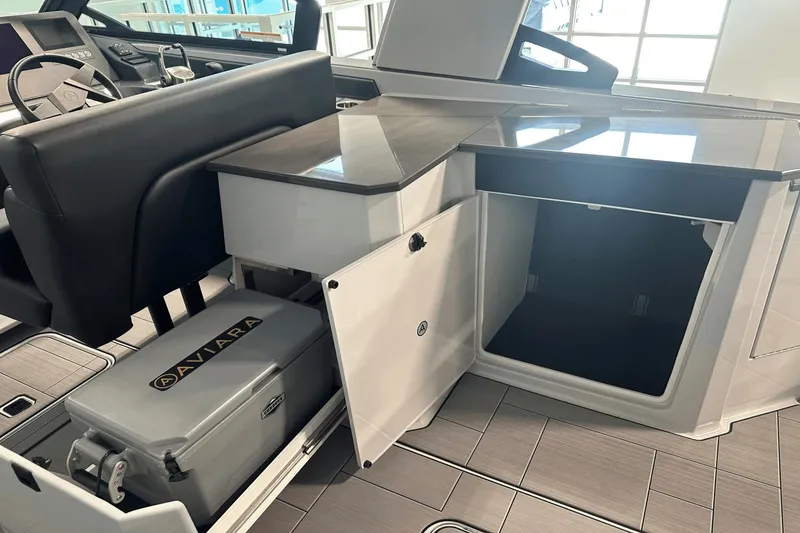 Slide: The Image of 2023 Aviara AV32 boat interior with storage compartment and cooler. - 14