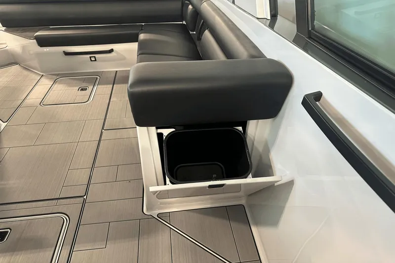 Slide: The Image of 2023 Aviara AV32 boat interior with sleek seating and hidden storage compartment. - 16