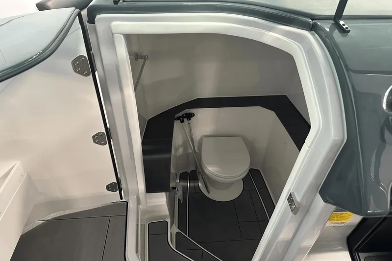 Slide: The Image of 2023 Aviara AV32 boat interior bathroom with modern design and compact toilet. - 18