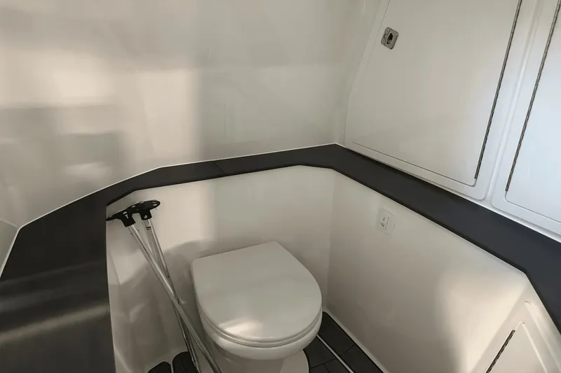 Slide: The Image of 2023 Aviara AV32 boat interior bathroom with modern design and compact toilet. - 19