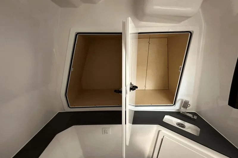 Slide: The Image of Interior storage compartment and sink in 2023 Aviara AV32 boat. - 20