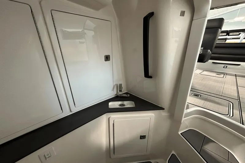 Slide: The Image of Interior of 2023 Aviara AV32 boat featuring sleek cabinetry and modern design elements. - 21