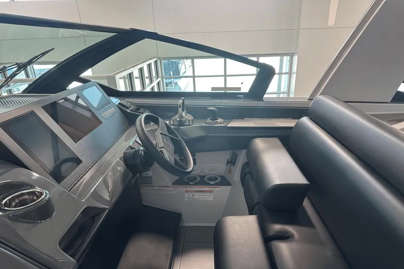 Slide: The Image of 2023 Aviara AV32 boat cockpit with modern steering and digital displays. - 22