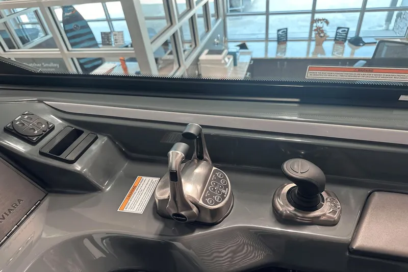 Slide: The Image of 2023 Aviara AV32 boat control panel with joystick and throttle levers. - 23