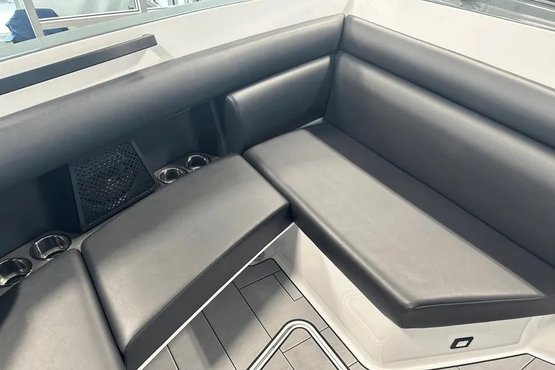 Slide: The Image of 2023 Aviara AV32 boat interior with sleek black seating and cup holders. - 27