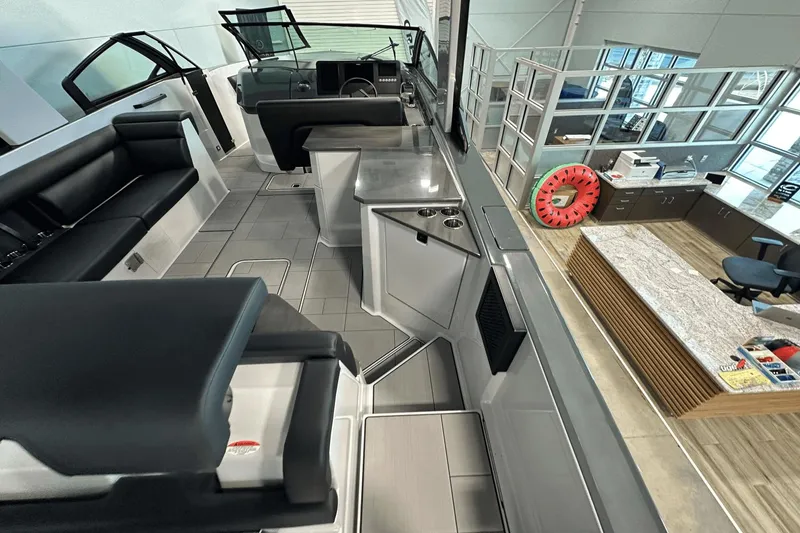 Slide: The Image of 2023 Aviara AV32 boat interior with sleek seating and modern design in showroom. - 8