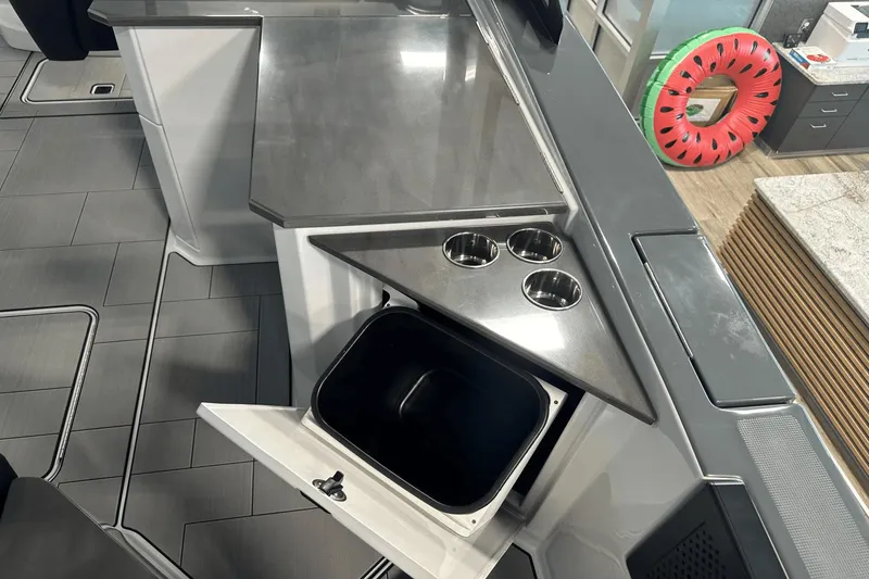 Slide: The Image of 2023 Aviara AV32 boat interior with sleek countertop and built-in storage. - 9