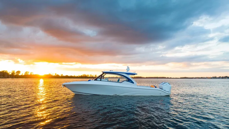 Slide: The Image of 2025 Fountain 39 DX boat on water at sunset. - 4