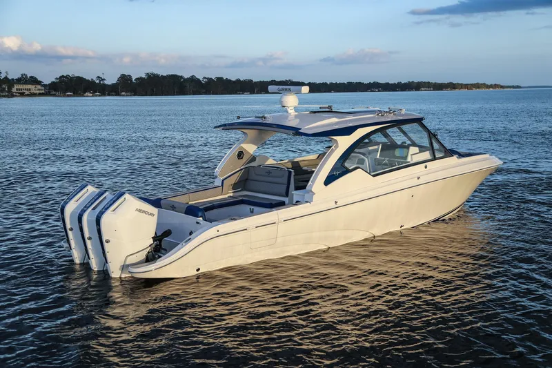 Slide: The Image of 2025 Fountain 39 DX boat with triple outboard engines on calm water. - 5