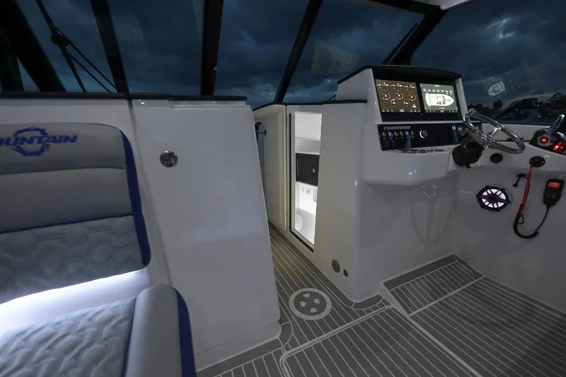 Slide: The Image of Interior of 2025 Fountain 39 DX boat with modern dashboard and seating. - 7