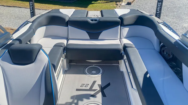 Slide: The Image of 2021 MasterCraft XT22 boat interior with sleek seating and modern design. - 13
