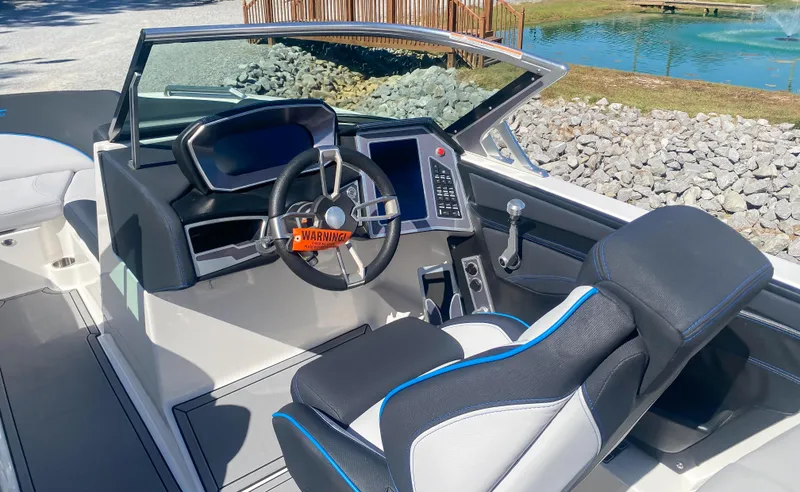 Slide: The Image of 2021 MasterCraft XT22 boat interior with modern dashboard and steering wheel. - 18
