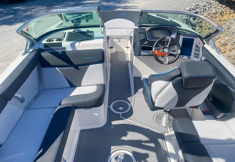 Slide: The Image of 2021 MasterCraft XT22 boat interior with modern seating and steering console. - 20