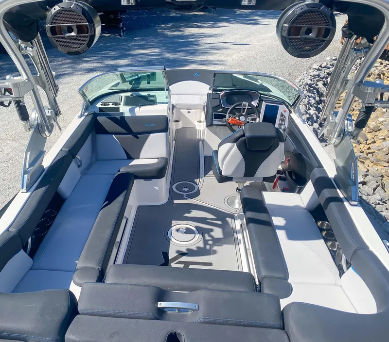 Slide: The Image of 2021 MasterCraft XT22 boat interior with seating and speakers. - 21