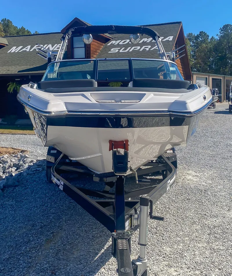 Slide: The Image of 2021 MasterCraft XT22 boat on trailer at marina, front view. - 9