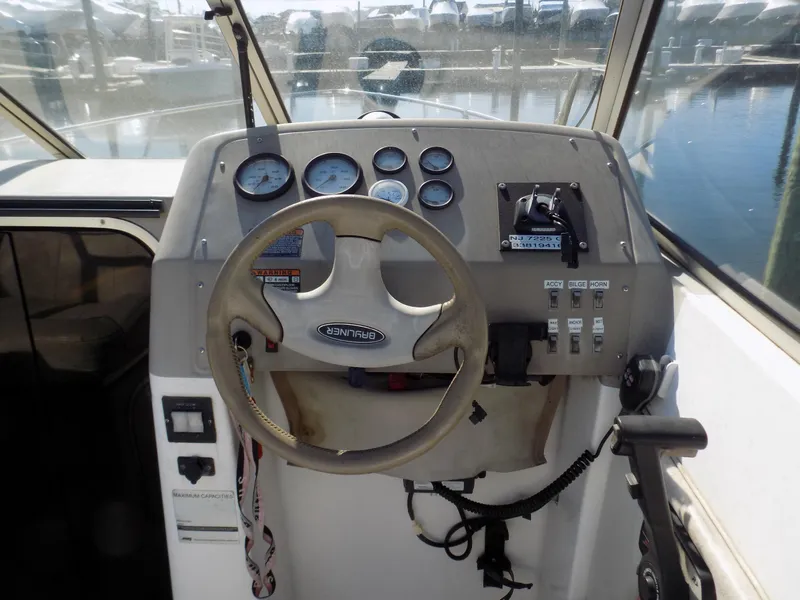 Slide: The Image of 2001 Bayliner 2252 Ciera Classic boat dashboard with steering wheel and gauges. - 3