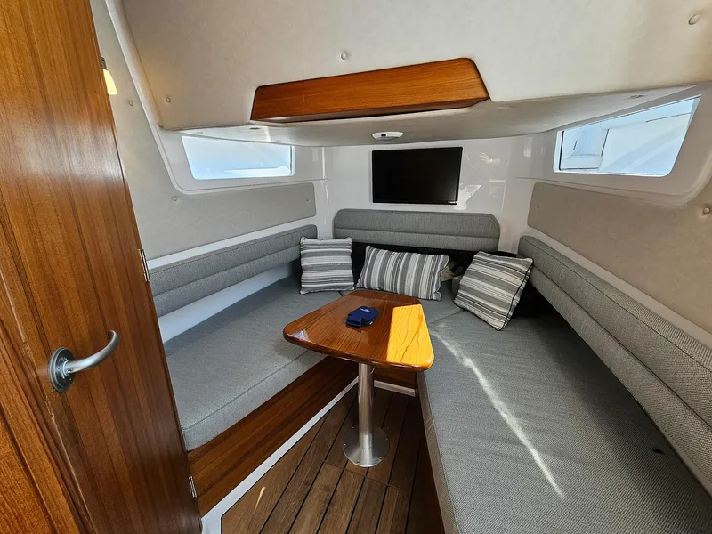 Slide: The Image of 2025 Southport 38 FE cabin interior with cozy seating and wooden accents. - 12