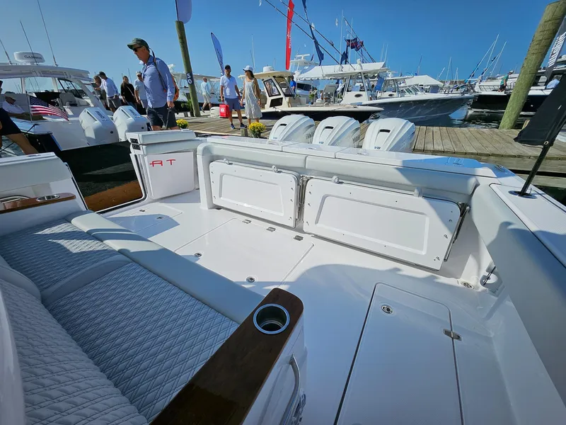 Slide: The Image of 2025 Southport 38 FE boat interior at marina, showcasing seating and deck features. - 3