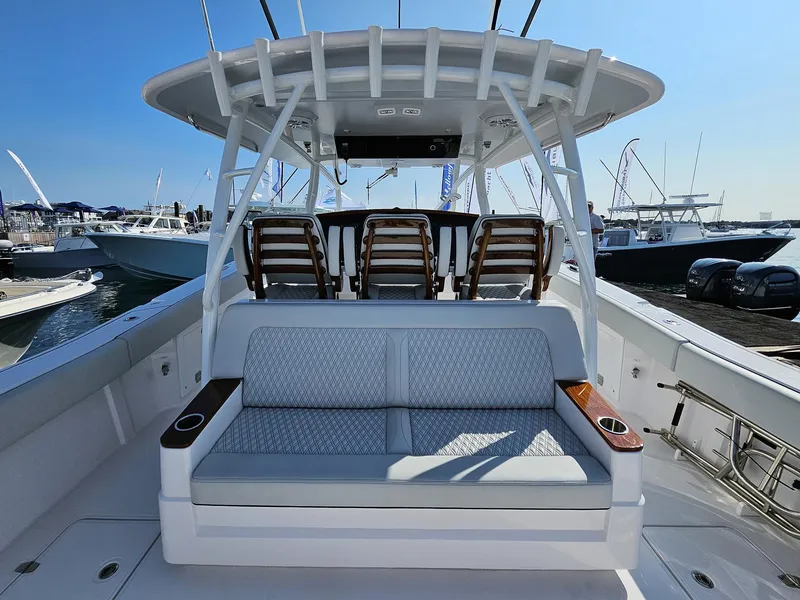 Slide: The Image of 2025 Southport 38 FE boat interior with seating and helm, docked at marina. - 5