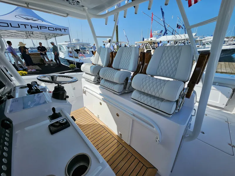 Slide: The Image of 2025 Southport 38 FE boat interior with luxurious seating and modern helm controls. - 6