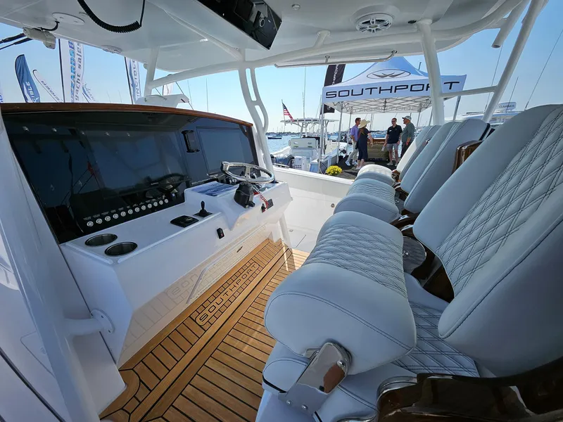Slide: The Image of 2025 Southport 38 FE boat interior with luxurious seating and modern dashboard. - 7