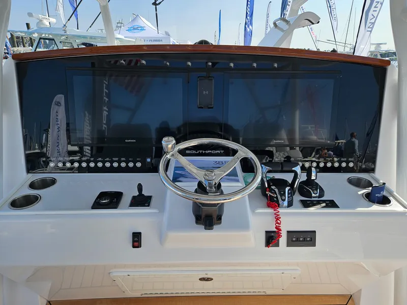 Slide: The Image of 2025 Southport 38 FE boat dashboard with steering wheel and control panel. - 8