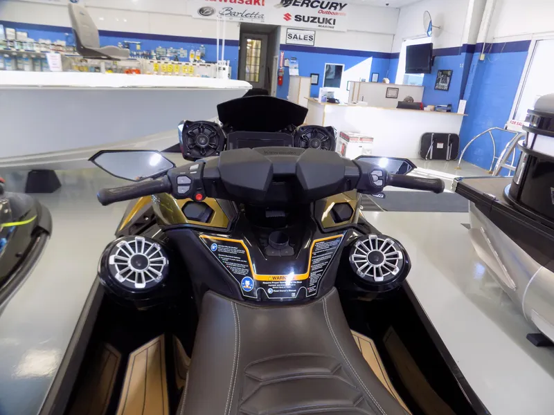 Slide: The Image of 2023 Kawasaki 310 LX jet ski dashboard in showroom, featuring advanced controls and speakers. - 3