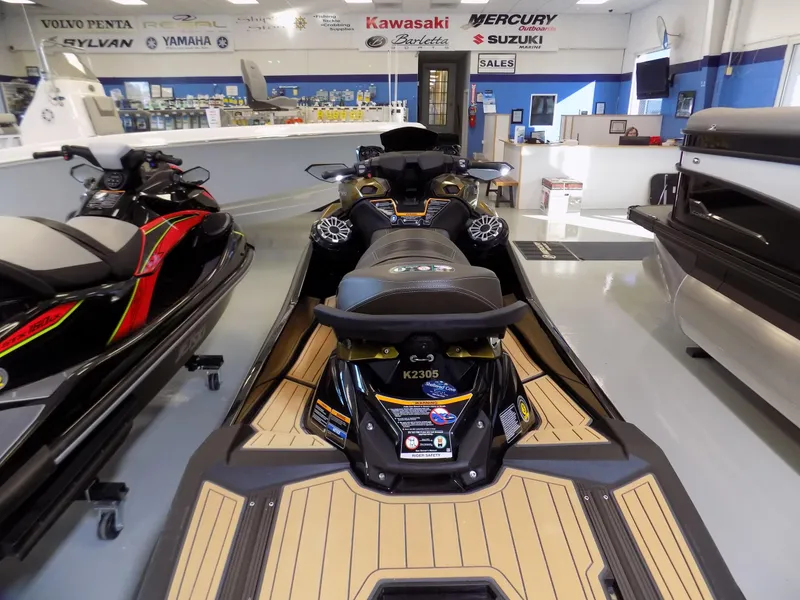 Slide: The Image of 2023 Kawasaki 310 LX jet ski displayed in a showroom with other watercraft. - 4