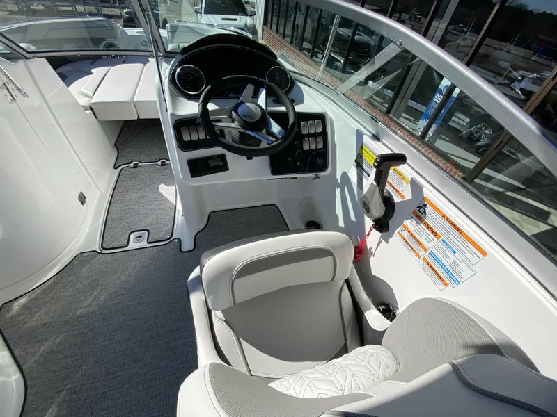Slide: The Image of 2023 Hurricane SD2200 boat interior with steering wheel and seating. - 10