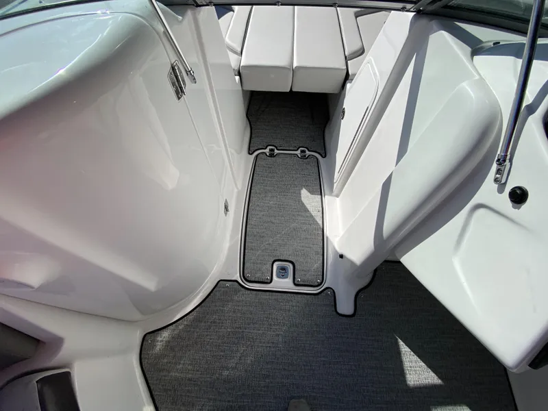 Slide: The Image of 2023 Hurricane SD2200 boat interior with gray carpet and white seating. - 12