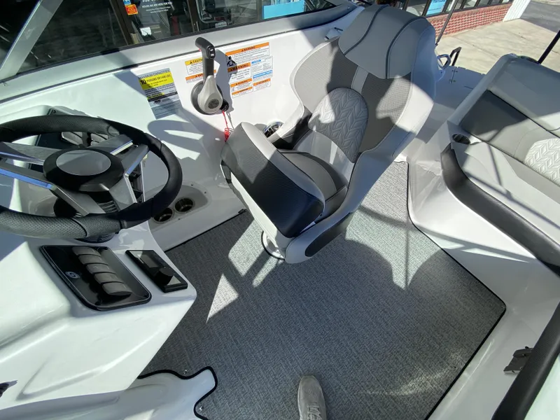 Slide: The Image of 2023 Hurricane SD2200 boat interior with steering wheel and captain's chair. - 14