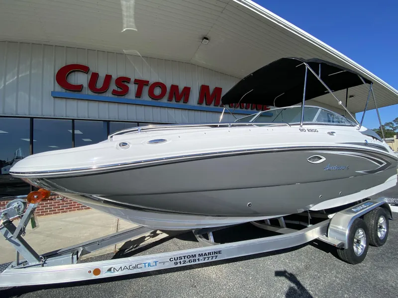 Slide: The Image of 2023 Hurricane SD2200 boat on trailer at Custom Marine dealership. - 2