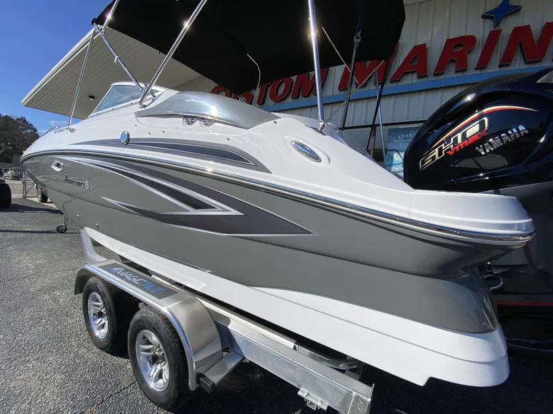 Slide: The Image of 2023 Hurricane SD2200 boat on trailer at marina, side view. - 3
