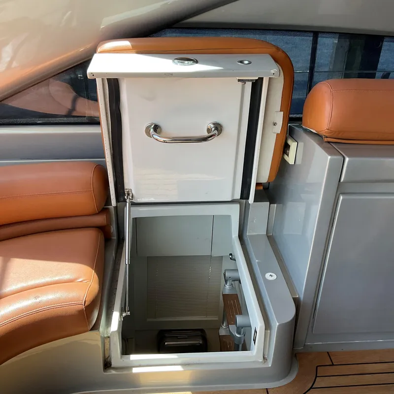 Slide: The Image of Open storage compartment on 2006 Pershing Cruiser with leather seating. - 11