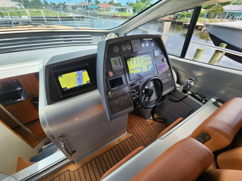 Slide: The Image of 2006 Pershing Cruiser helm with advanced navigation system and luxurious interior. - 13