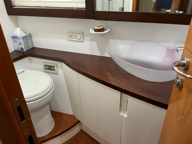 Slide: The Image of Luxurious bathroom in 2006 Pershing Cruiser with modern sink and toilet. - 22