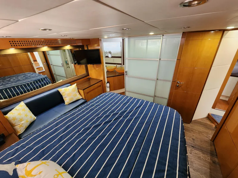 Slide: The Image of Luxurious bedroom interior of a 2006 Pershing Cruiser yacht with modern amenities. - 26