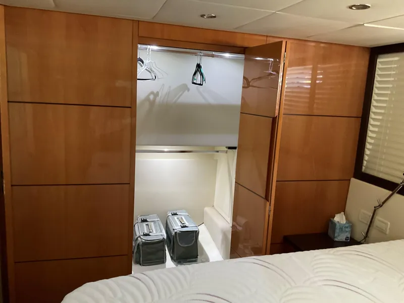 Slide: The Image of Luxurious 2006 Pershing Cruiser interior with wooden closet and modern design. - 29