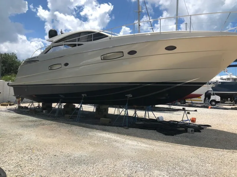 Slide: The Image of 2006 Pershing Cruiser yacht on dry dock under a partly cloudy sky. - 3