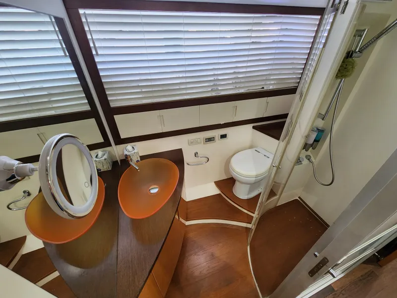 Slide: The Image of Luxurious bathroom in a 2006 Pershing Cruiser yacht with modern fixtures and wooden flooring. - 31