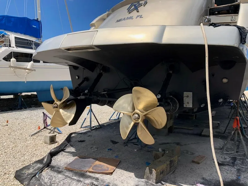Slide: The Image of 2006 Pershing Cruiser propellers and stern view in a boatyard setting. - 4