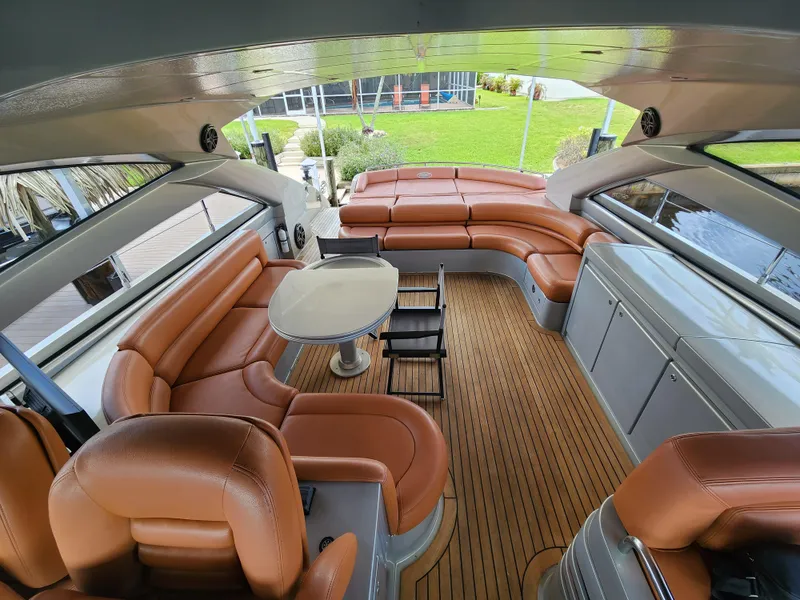 Slide: The Image of Luxurious interior of a 2006 Pershing Cruiser with leather seating and wooden flooring. - 5