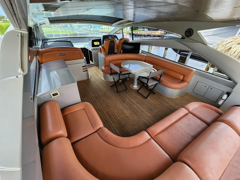 Slide: The Image of Luxurious interior of a 2006 Pershing Cruiser with leather seating and wooden flooring. - 7