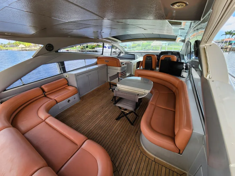 Slide: The Image of 2006 Pershing Cruiser interior with leather seating and wooden flooring. - 8