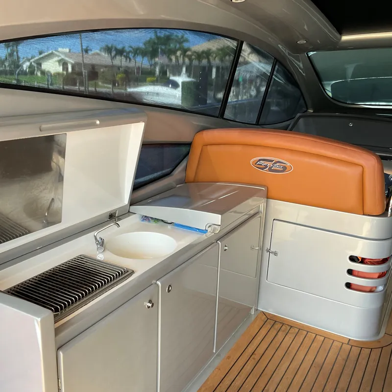 Slide: The Image of Interior of a 2006 Pershing Cruiser with kitchenette and seating area. - 9